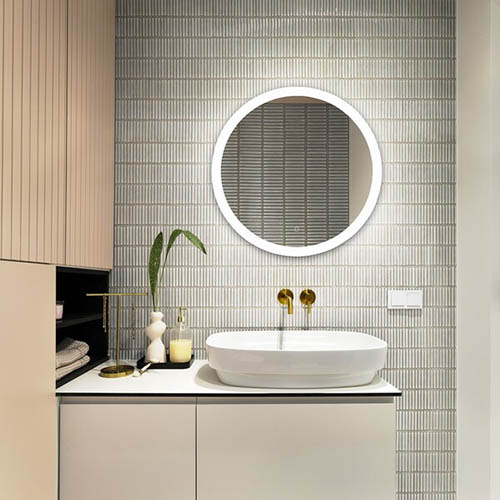 Interior design of elegant bathroom with gold tape, blue tiles, classic white sink, glass soap dispenser, beige wase with green leaves and personal accessories. Home decor. Template.